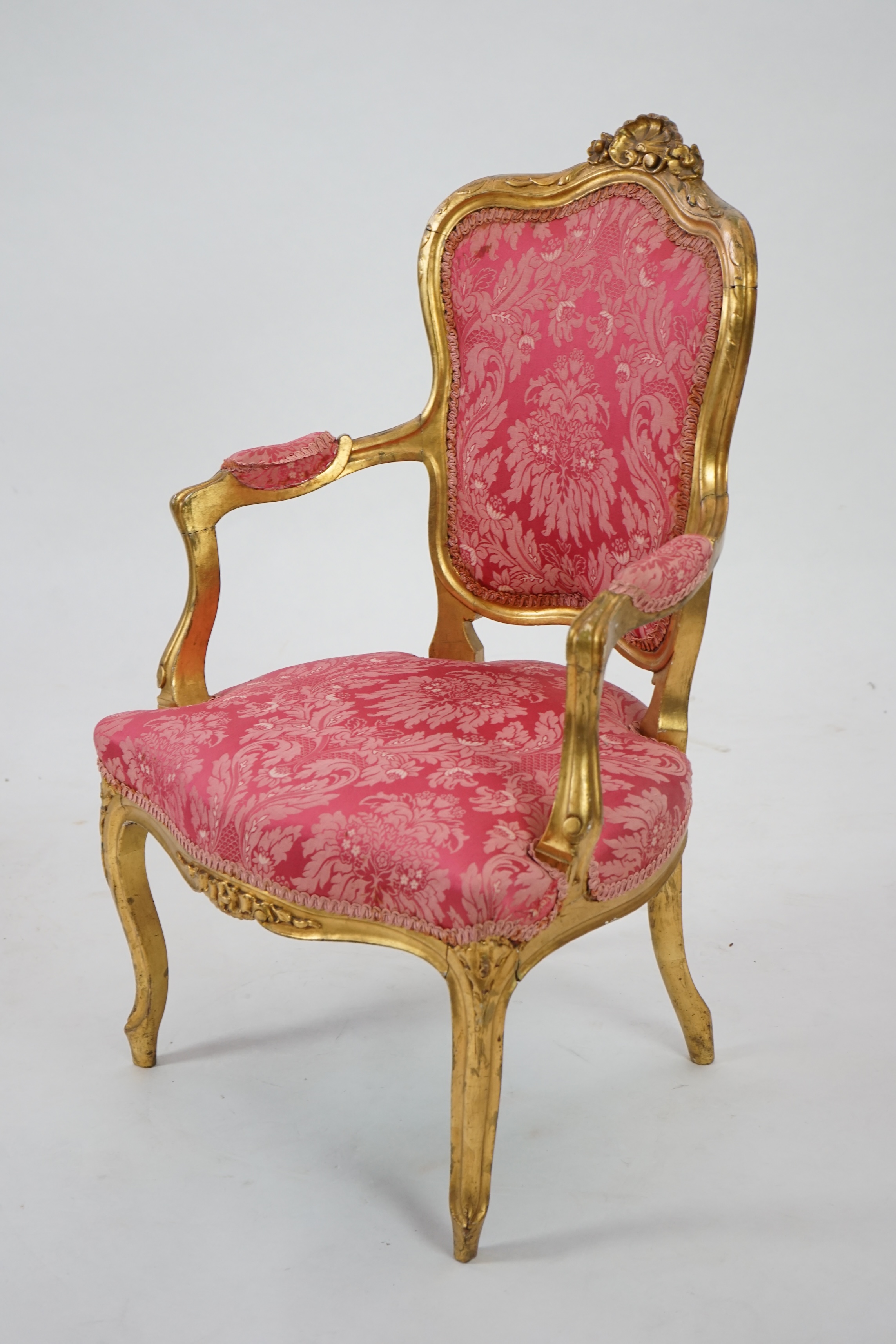 A Louis XV style carved giltwood fauteuil